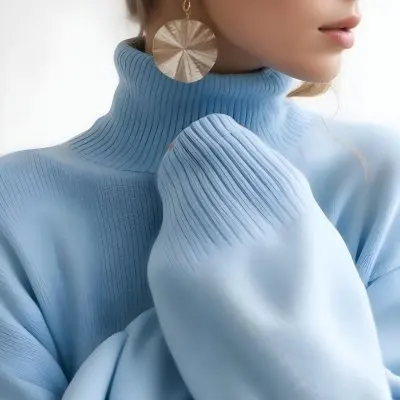 A Young Woman With Long Light Hair Wearing A Light Blue Turtleneck Sweater And Large Round Earrings 2 Eb2b