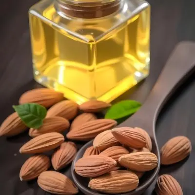 Almonds And Yellow Leaves In A Wooden Spoon With A Glass Bottle Full Of Green Oil On A Dark Wooden Table 13 5571