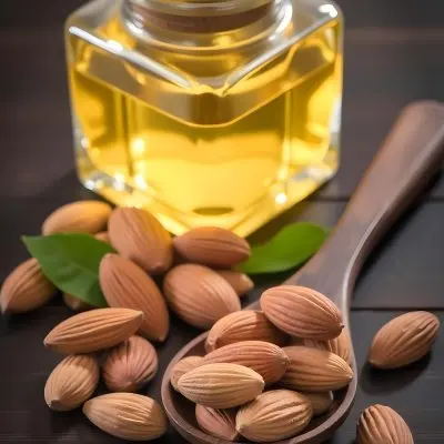 Almonds And Yellow Leaves In A Wooden Spoon With A Glass Bottle Full Of Green Oil On A Dark Wooden Table 7 E485