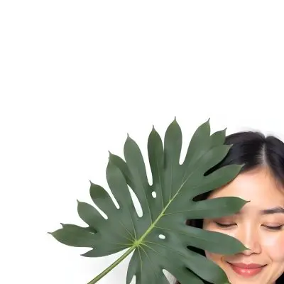 An Asian Woman 23 Years Old With Black Hair Holding A Green Leaf In Front Of Her Face Eyes Closed Black Background 37 8c68