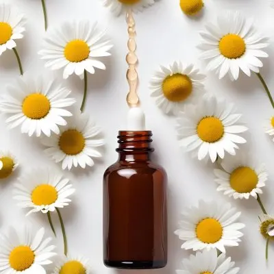 Brown Glass Bottle With Dropper Surrounded By Chamomile Flowers White Background 31 0db8