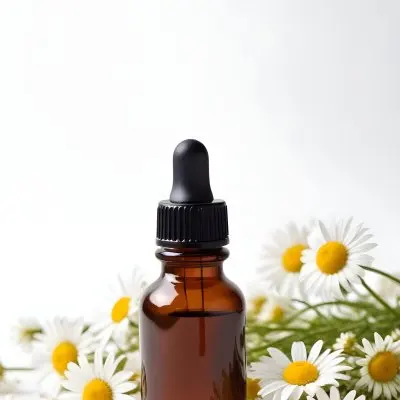 Brown Glass Bottle With Dropper Surrounded By Chamomile Flowers White Background 33 C94e