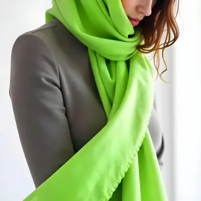 Caucasian Woman Age 25 With Brown Hair Partially Covered By A Vibrant Green Fabric In A Minimalist Gray And White Indoor Setting 2 D651