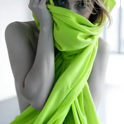 Caucasian Woman Age 25 With Brown Hair Partially Covered By A Vibrant Green Fabric In A Minimalist Gray And White Indoor Setting 23 44bd