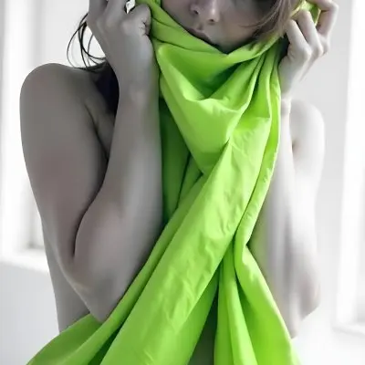 Caucasian Woman Age 25 With Brown Hair Partially Covered By A Vibrant Green Fabric In A Minimalist Gray And White Indoor Setting 29 10e9