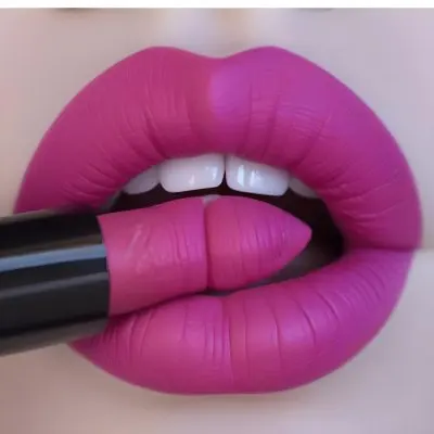 Close Up Of A Pair Of Lips With A Vibrant Matte Fuchsia Lipstick Being Applied The Lips Are Full With Visible Texture A Lipstick Bullet In A Similar Shade Is Positioned Against The Lips Emphasizing The Makeup Applic 18 9ece