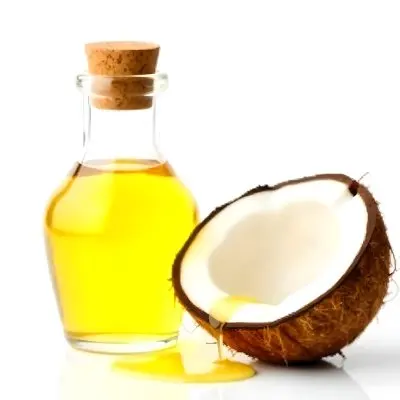 Coconut Oil Bottle With Cork Next To A Halved Coconut With Oil Dripping In A White Background 10 9f9f