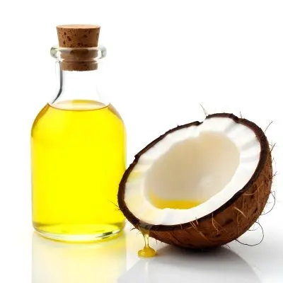 Coconut Oil Bottle With Cork Next To A Halved Coconut With Oil Dripping In A White Background 18 4a89