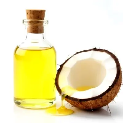 Coconut Oil Bottle With Cork Next To A Halved Coconut With Oil Dripping In A White Background 26 E85a