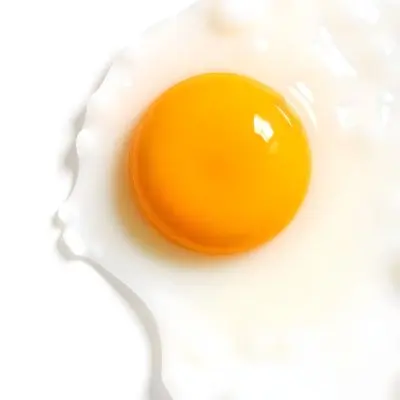 A Fried Egg With A Bright Yellow Yolk And Translucent White On A White Surface Top Down View Studio Lighting Food Photography 17 67eb