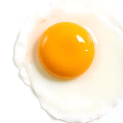 A Fried Egg With A Bright Yellow Yolk And Translucent White On A White Surface Top Down View Studio Lighting Food Photography 27 Ca7d