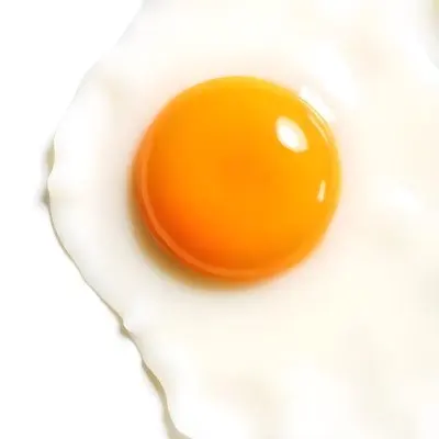 A Fried Egg With A Bright Yellow Yolk And Translucent White On A White Surface Top Down View Studio Lighting Food Photography 28 7373