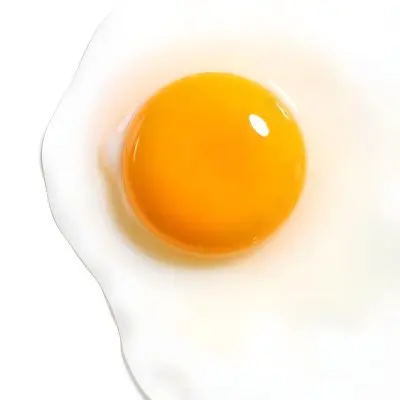 A Fried Egg With A Bright Yellow Yolk And Translucent White On A White Surface Top Down View Studio Lighting Food Photography 52 0287