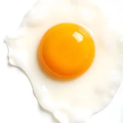 A Fried Egg With A Bright Yellow Yolk And Translucent White On A White Surface Top Down View Studio Lighting Food Photography 7 C9fd