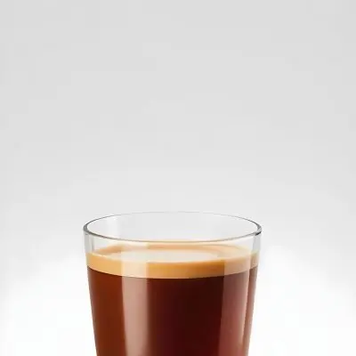 A Glass Of Dark Coffee With A Layer Of Light Brown Foam On Top Against A Plain White Background 15 C456