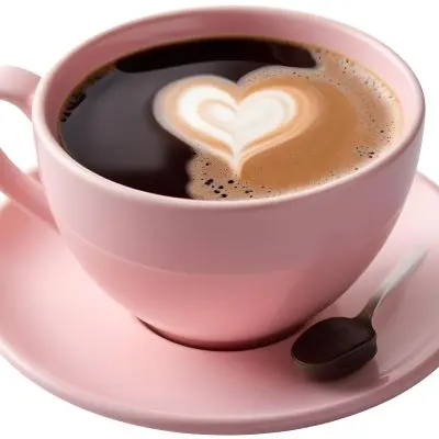 A Pink Ceramic Cup Filled With A Creamy Frothy Latte Or Cappuccino Featuring An Intricate Latte Art Design On The Surface Of The Drink Placed On A Wooden Table In A Sunlit Kitchen With Morning Ligh 9 1c47