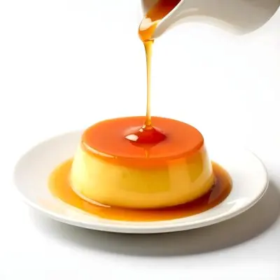 Caramel Flan With Caramel Syrup Being Poured On Top On A White Background 34 392c