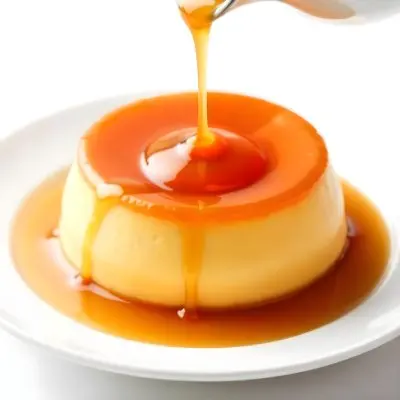 Caramel Flan With Caramel Syrup Being Poured On Top On A White Background 36 2557