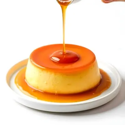 Caramel Flan With Caramel Syrup Being Poured On Top On A White Background 5 0f48