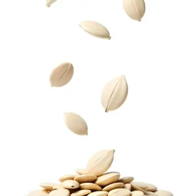 Pumpkin Seeds Falling Into A Pile Of Pumpkin Seeds Isolated On A White Background 5 Ef9a