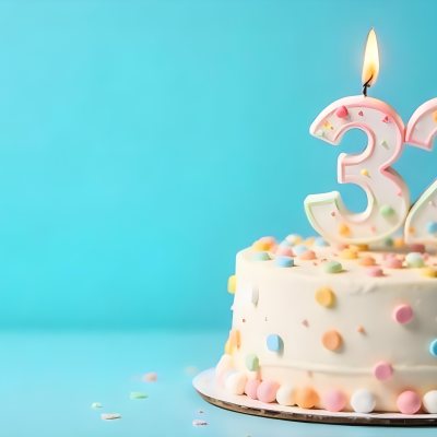 A Birthday Cake With Pastel Colors And A Number 32 Candle On Top In Front Of A Blue Background 9 3113