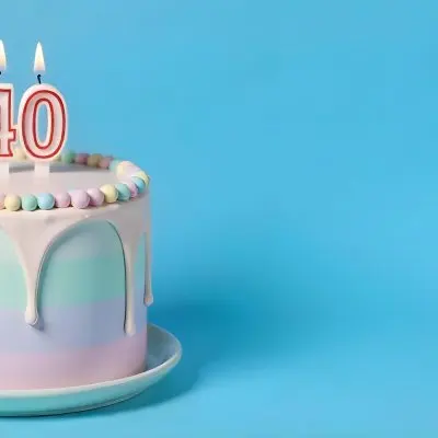 A Birthday Cake With Pastel Colors And Number 40 Candles On A Green Plate Light Purple And Green Frosting Plain White Background 23 6e07