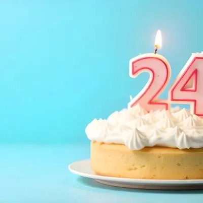 A Birthday Cake With White Frosting And A Candle In The Shape Of The Number 24 Light Blue Background 17 9eba