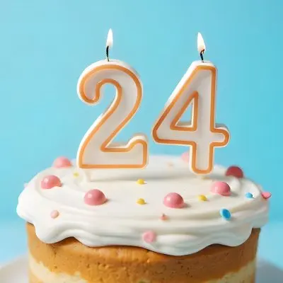 A Birthday Cake With White Frosting And A Candle In The Shape Of The Number 24 Light Blue Background 22 509d
