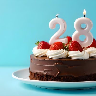 Chocolate Cake With Strawberries And Cream Two Candles With The Number 28 On Top Of A White Plate In A Blue Background 1 De11