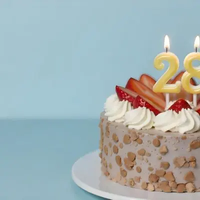 Chocolate Cake With Strawberries And Cream Two Candles With The Number 28 On Top Of A White Plate In A White Background 4 D926