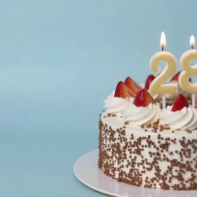 Chocolate Cake With Strawberries And Cream Two Candles With The Number 28 On Top Of A White Plate In A White Background 7 Cc30