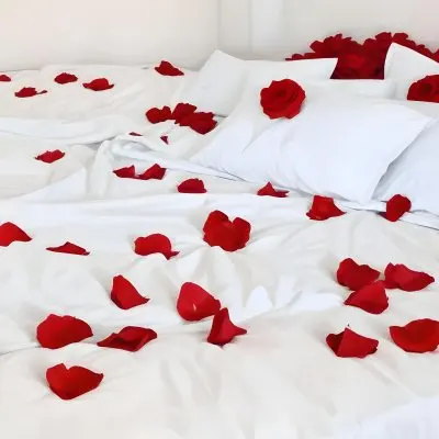 White Bed With Red Pillows And Sheets Covered With Red Rose Petals In A Bedroom 9 F5b1