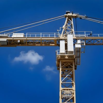 A Large Yellow Construction Crane Against A Bright Blue Sky 1 7c7b