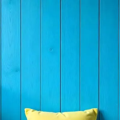 A Blue Wooden Wall With Vertical Planks A Cushions In The Foreground 2 17cc