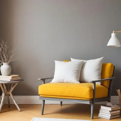 A Gray Armchair With A White Pillow Next To A Small Table With A Book And Some Sticks In A Yellow Room 13 C103