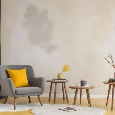 A Gray Armchair With A White Pillow Next To A Small Table With A Book And Some Sticks In A Yellow Room 22 3c27