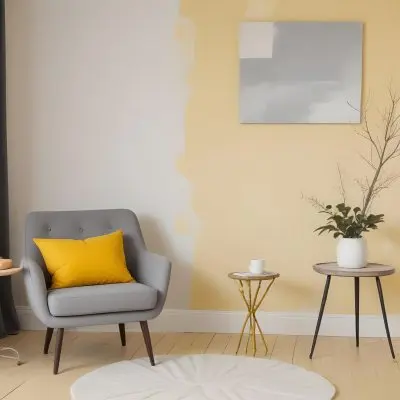 A Gray Armchair With A White Pillow Next To A Small Table With A Book And Some Sticks In A Yellow Room 27 2a66
