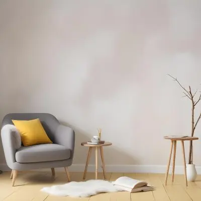 A Gray Armchair With A White Pillow Next To A Small Table With A Book And Some Sticks In A Yellow Room 5 9b66