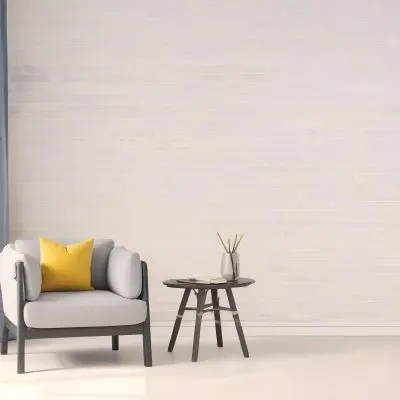A Gray Armchair With A White Pillow Next To A Small Table With A Book And Some Sticks In A Yellow Room 5 A987