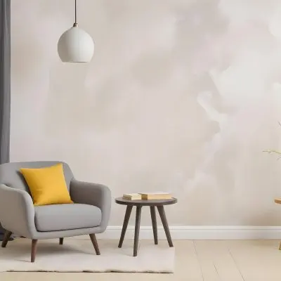 A Gray Armchair With A White Pillow Next To A Small Table With A Book And Some Sticks In A Yellow Room 7 Bcc9