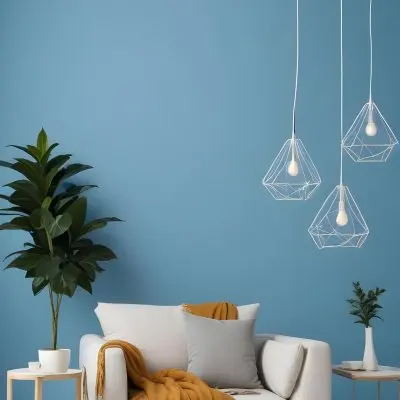 A Modern Living Room With A White Sofa A Potted Plant And Geometric Pendant Lights Hanging From The Ceiling Against A Blue Wall 13 255d