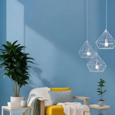 A Modern Living Room With A White Sofa A Potted Plant And Geometric Pendant Lights Hanging From The Ceiling Against A Blue Wall 35 3da7