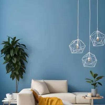 A Modern Living Room With A White Sofa A Potted Plant And Geometric Pendant Lights Hanging From The Ceiling Against A Blue Wall 37 07b2