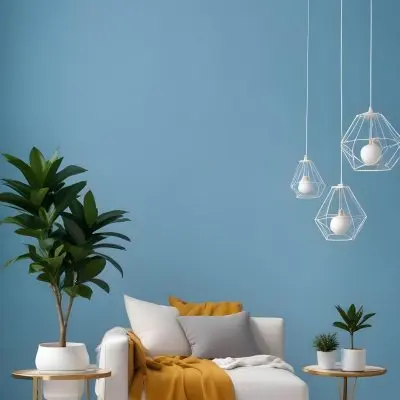 A Modern Living Room With A White Sofa A Potted Plant And Geometric Pendant Lights Hanging From The Ceiling Against A Blue Wall 4 6aa7