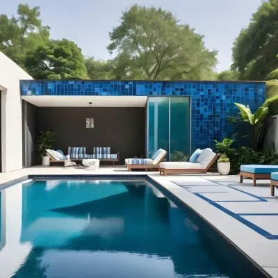 A Modern Outdoor Pool Area With A Rectangular Pool Surrounded By Lounge Chairs And Cabanas The Pool Has A Tiled Blue Bottom And The Surrounding Area Features Lush Greenery And A White Building With Bl 13 72bd
