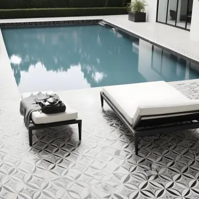 A Modern Outdoor Pool Area With A Rectangular Pool Surrounded By Lounge Chairs And Cabanas The Pool Has A Tiled Blue Bottom And The Surrounding Area Features Lush Greenery And A White Building With Bl 8 C81d