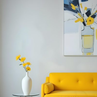 A White Sofa With A White Pillow A Yellow Vase And A Glass On A Table In Front Of A Yellow Wall 17 E94f