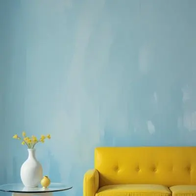 A White Sofa With A White Pillow A Yellow Vase And A Glass On A Table In Front Of A Yellow Wall 5 D7c6