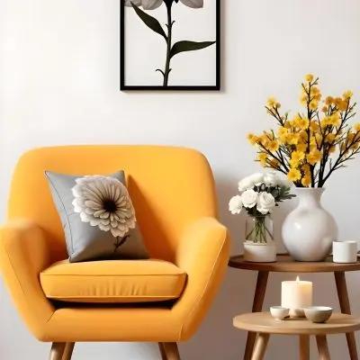 Yellow Armchair With A Flower Pillow Next To A Wooden Table With A Vase Of White Flowers A Cup Of Tea And A Candle With A Yellow Wall And A Framed Picture In The Background 26 266a