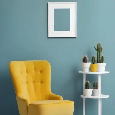 Yellow Armchair With A White Frame On The Wall And A White Table With Cactuses In A Blue Room 17 Bf5e
